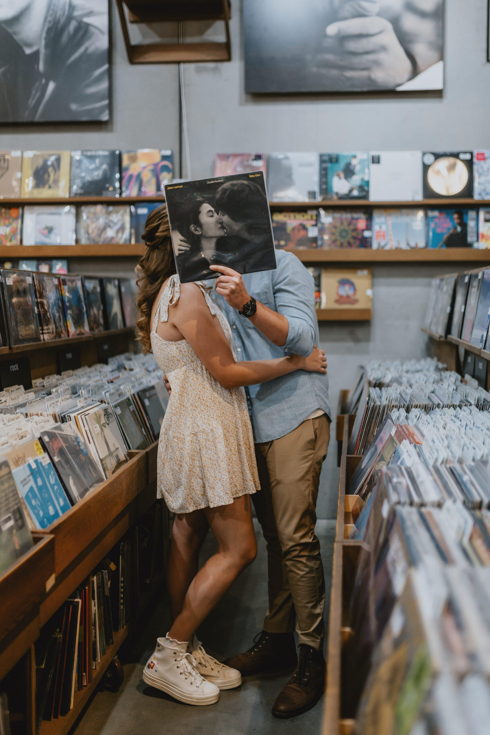 couple posing with a vinyl in a record store