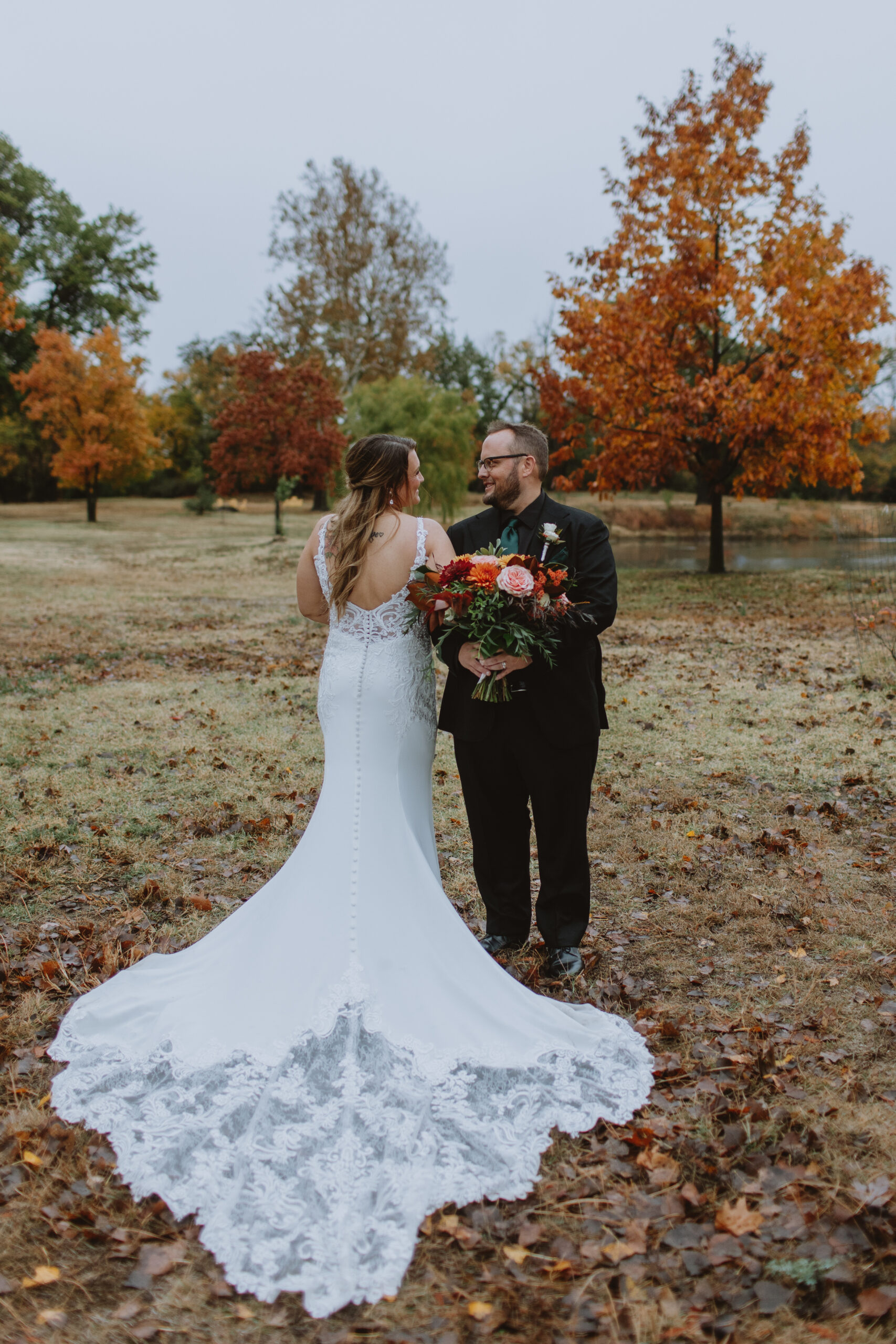 bride and groom standing outside