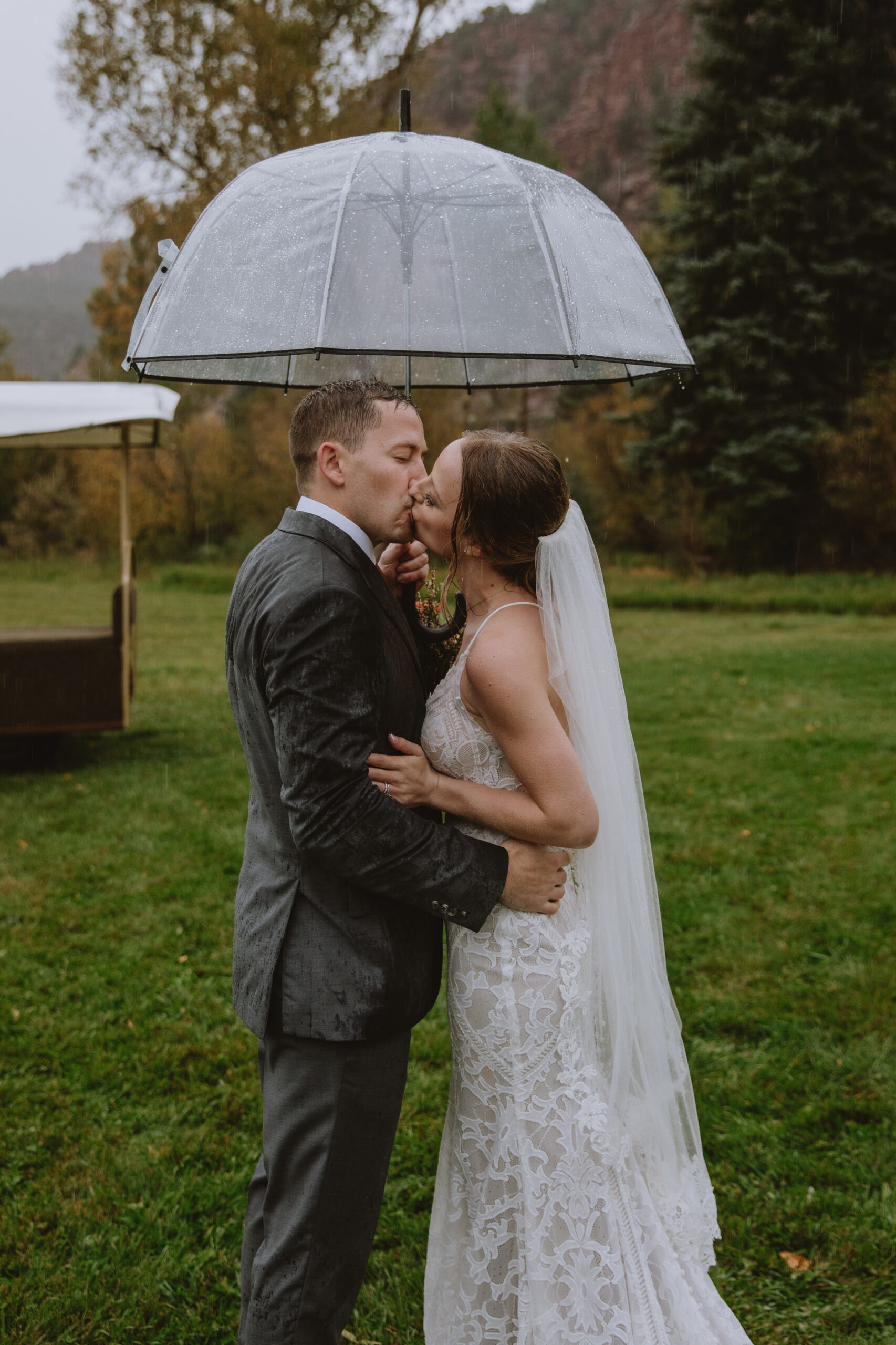 bride and groom under an umbrella