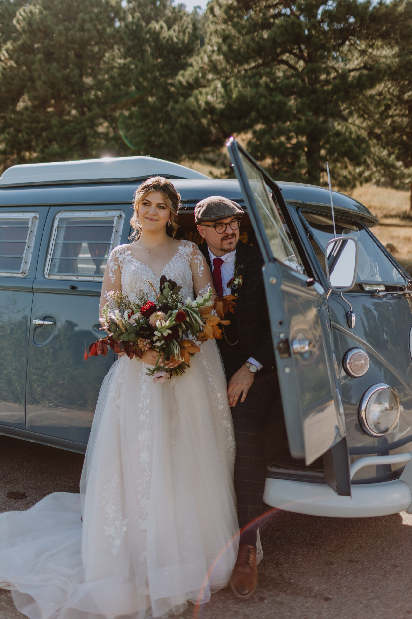 bride and groom standing in front of a vw bus