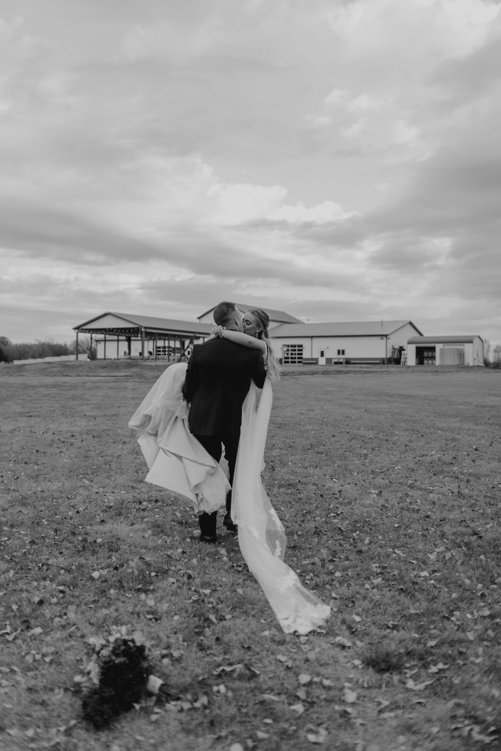 groom carrying bride
